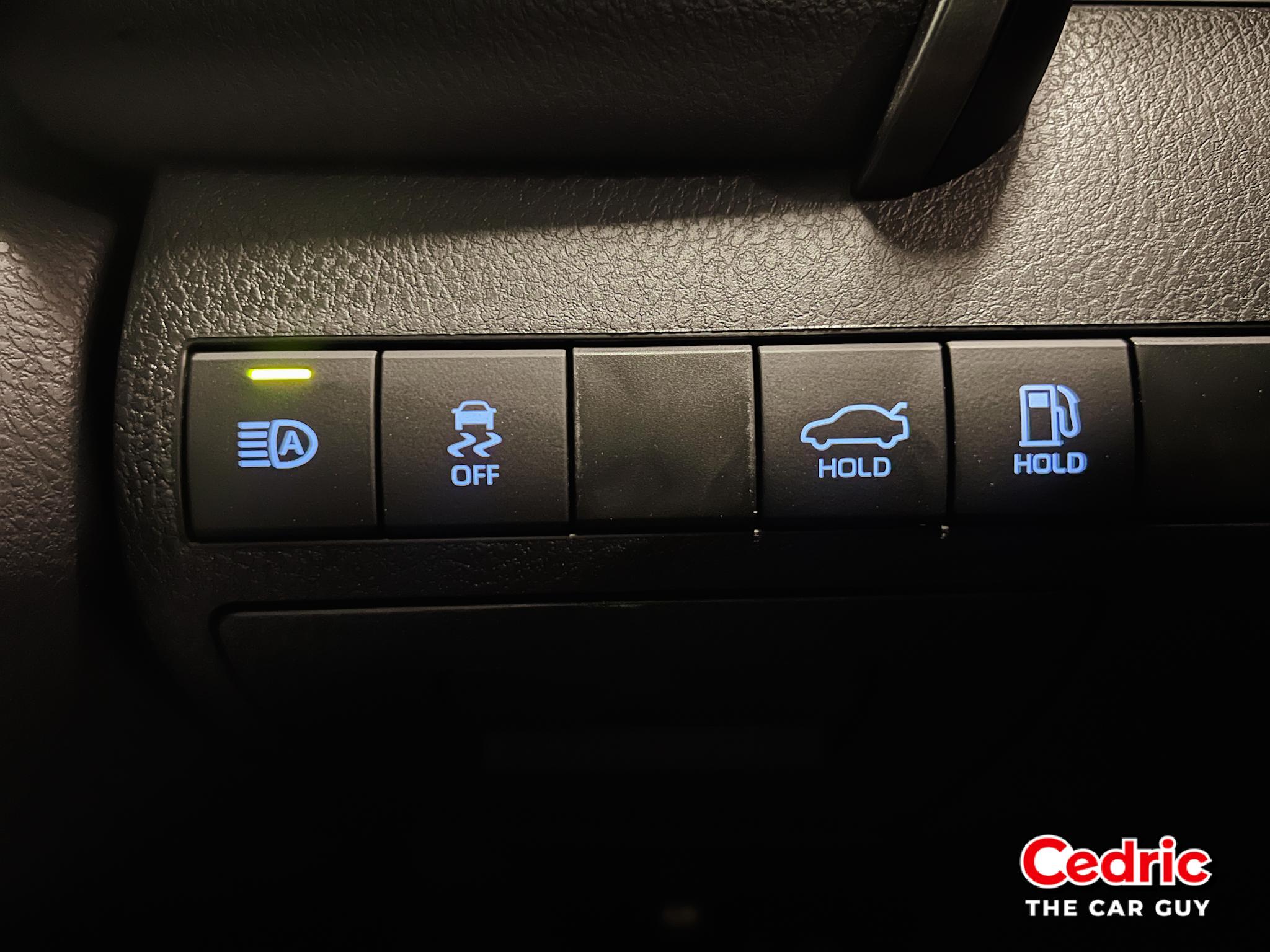 Console switch controlling the automatic high beams, traction control, trunk, and gas door release switches