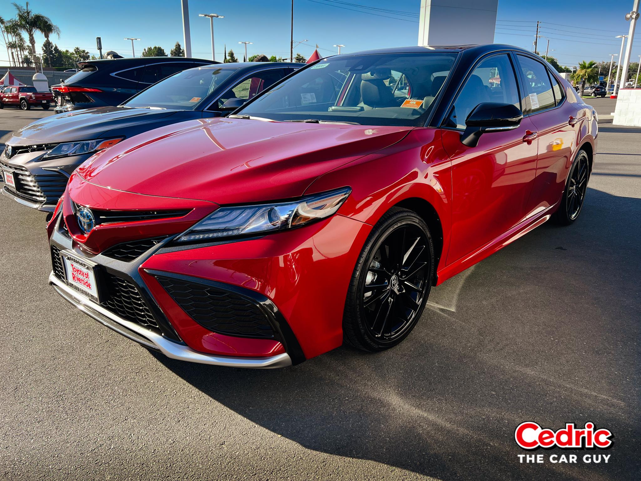 Toyota Camry XSE Hybrid in Supersonic Red Metallic with Black Roof, Black Wheels and comes standard with Vehicle Stability Control