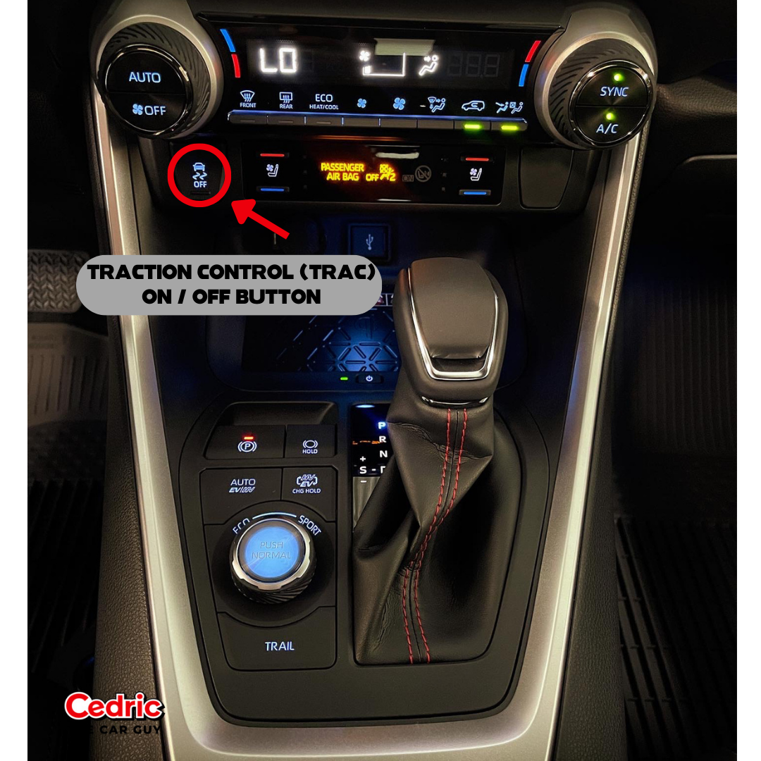 The Traction Control switch located above the Trail, Eco, Sport, and EV Mode selector console on the Toyota RAV4 Hybrid AWD