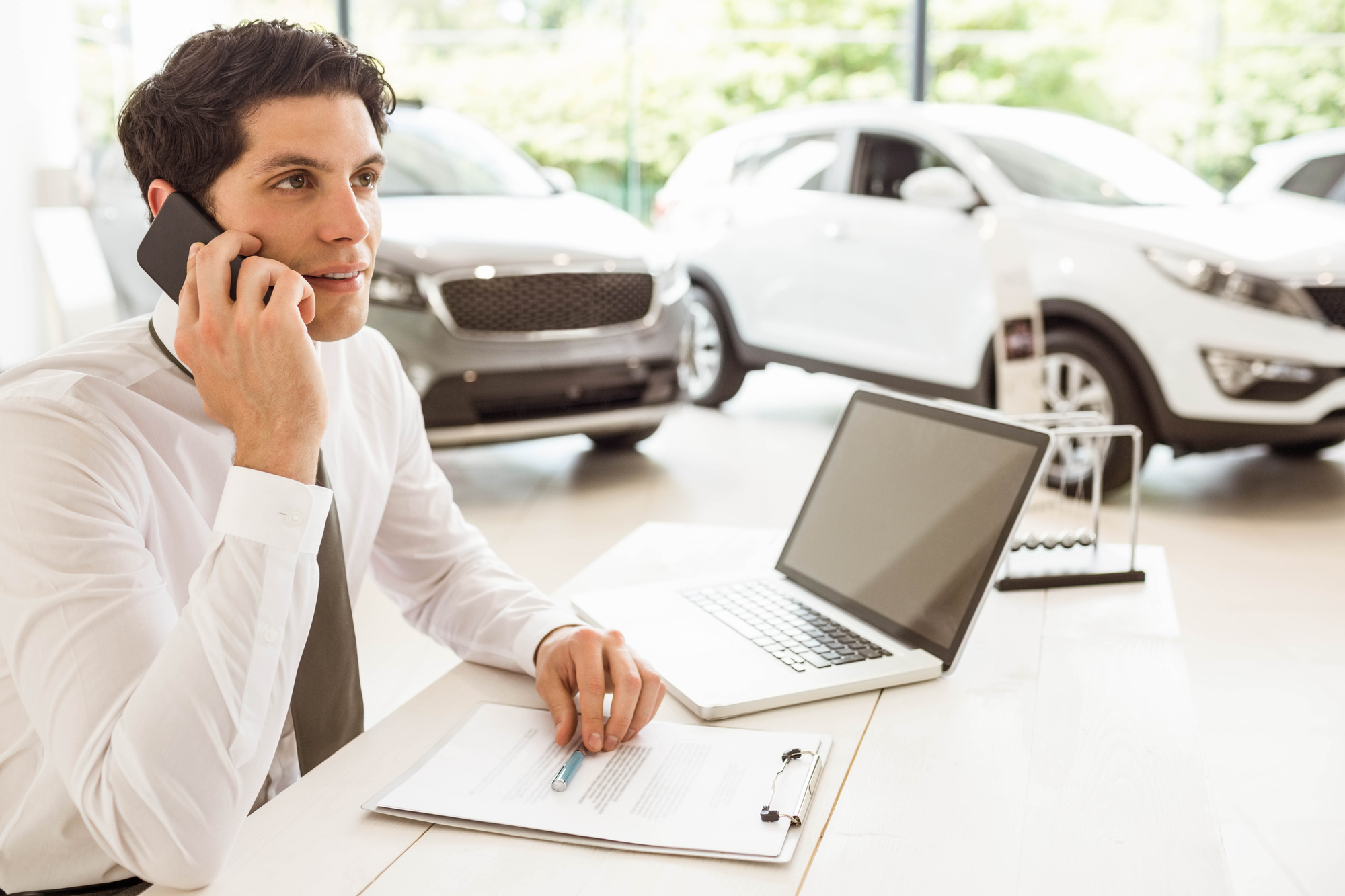 car salesmen verifying a car is in stock and available