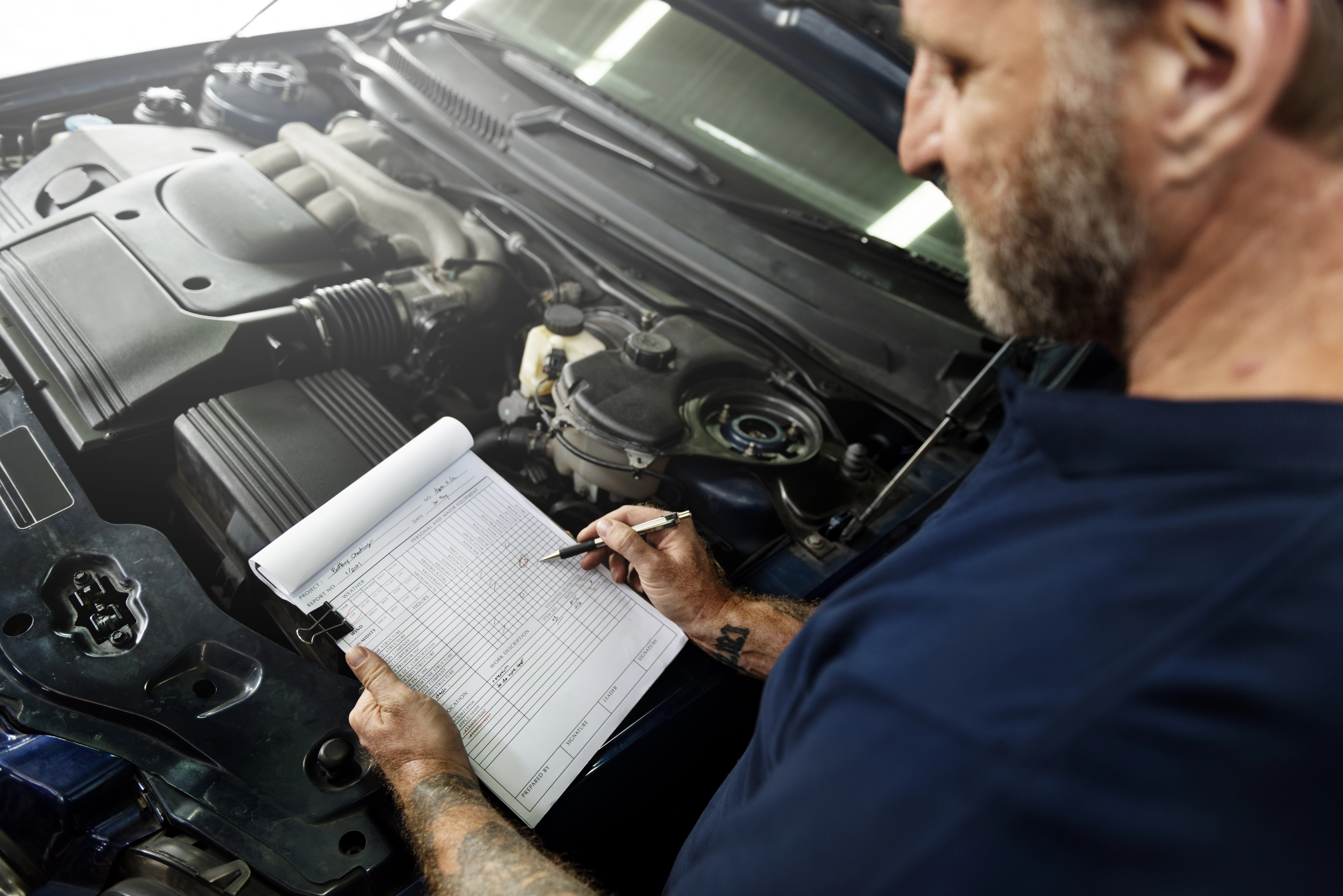 mechanic inspecting a used car