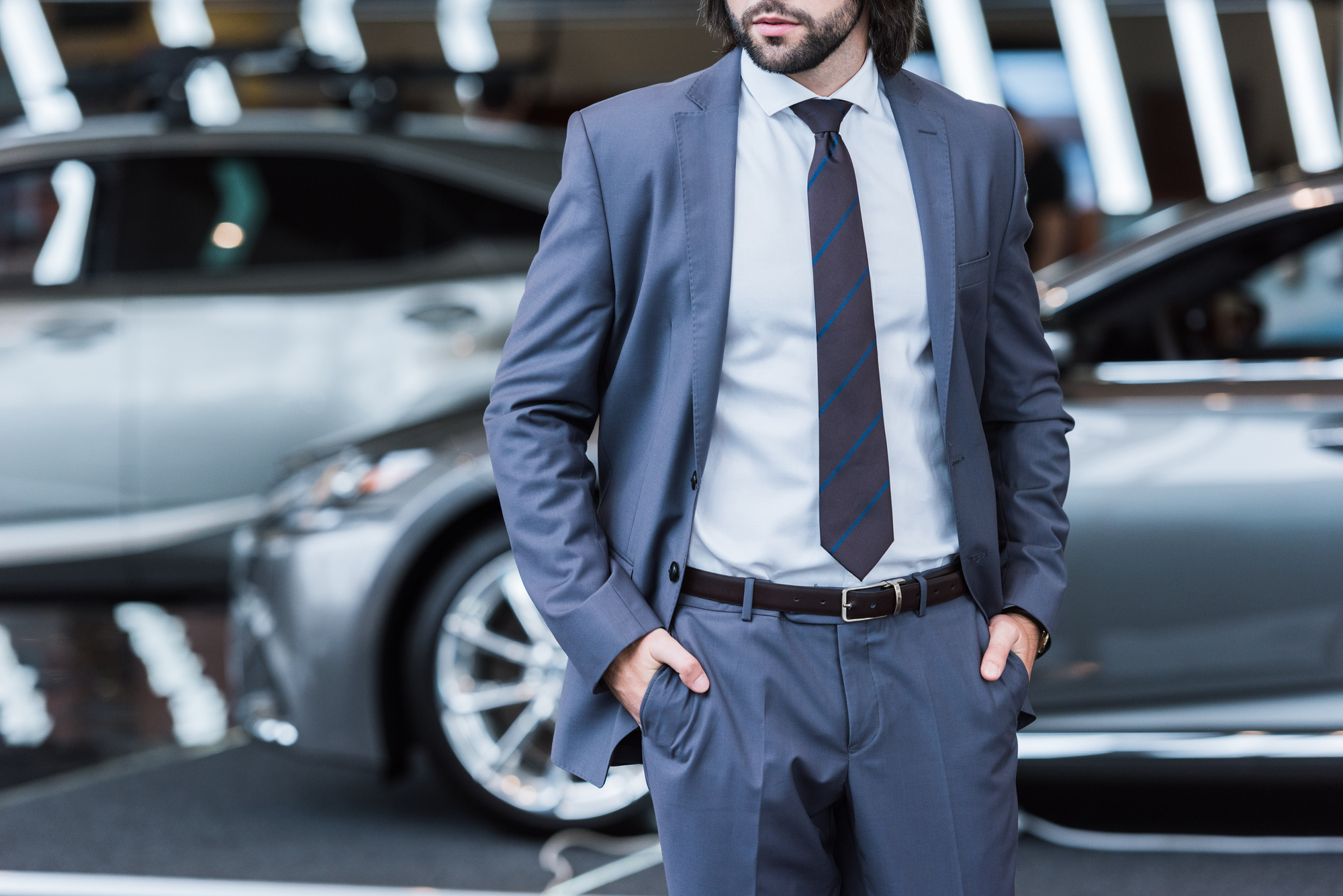 car salesmen in front of car dealership