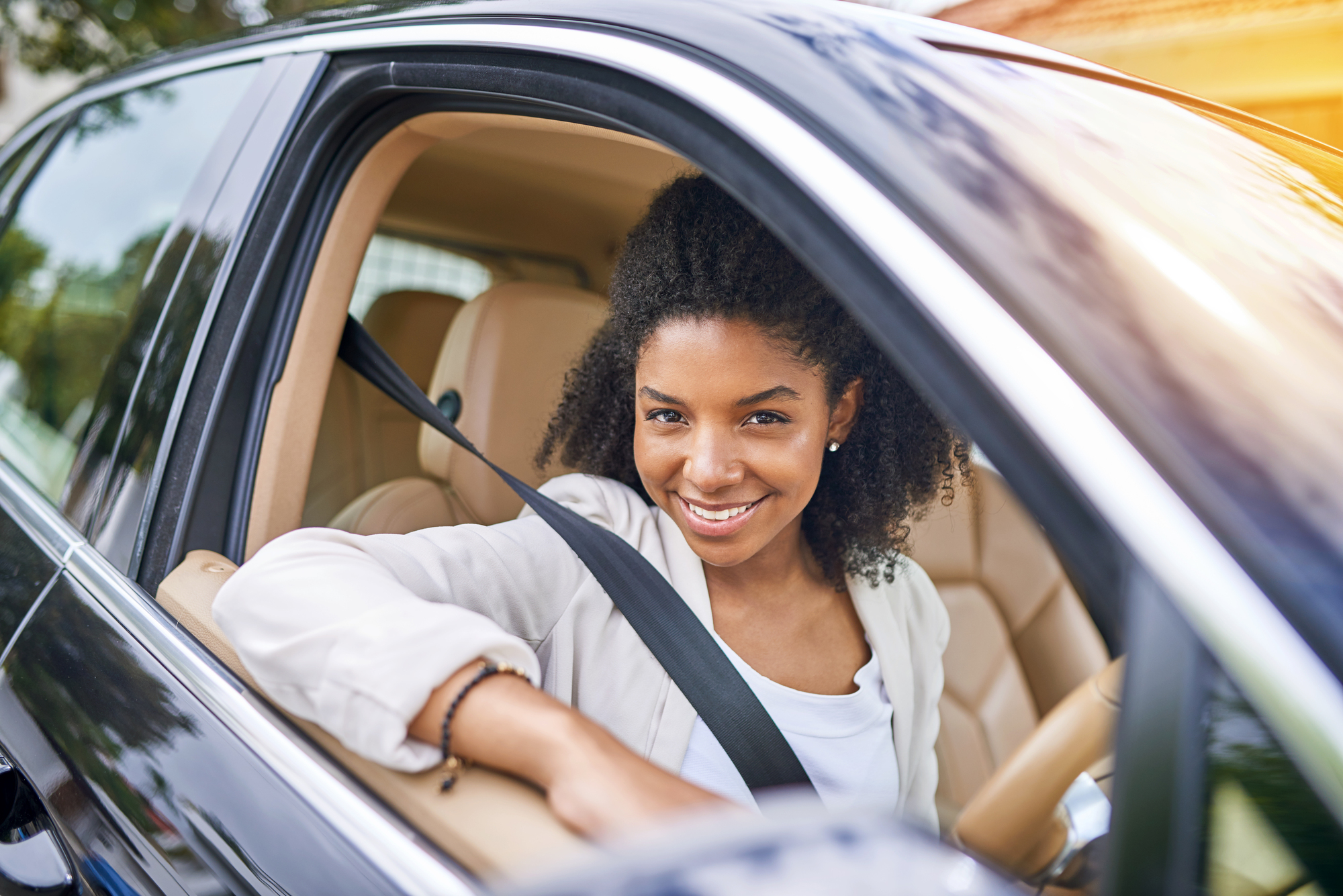 happy customer in her brand-new car