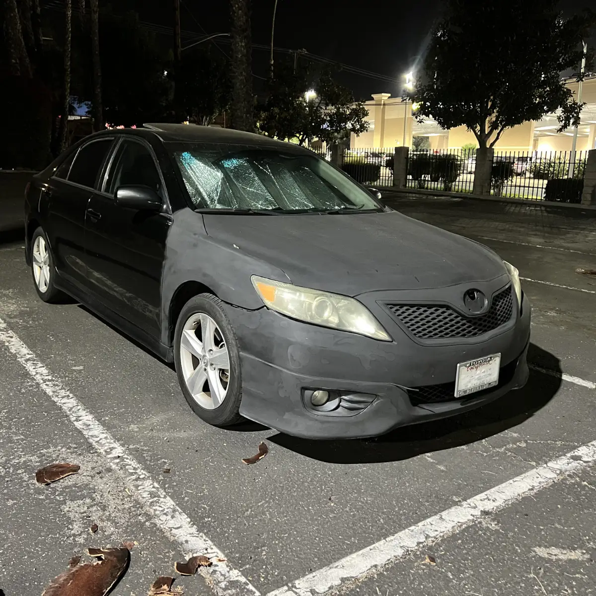 Cedric's 2011 Toyota Camry with faded and primered paint — the car he drove while building his business